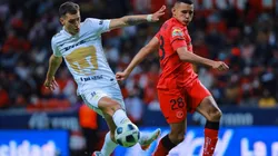 Oscar Venegas of Toluca struggles for the ball against Juan Dinenno of Pumas during the repechage match between Toluca and Pumas