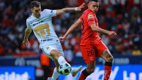 Oscar Venegas of Toluca struggles for the ball against Juan Dinenno of Pumas during the repechage match between Toluca and Pumas