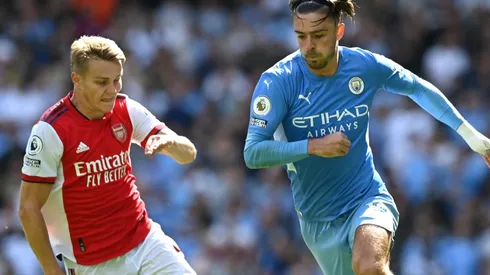 Jack Grealish of Manchester City breaks away from Martin Odegaard of Arsenal.