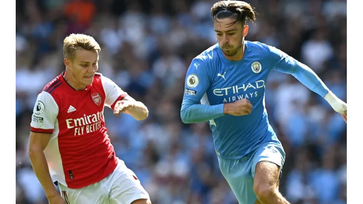 Jack Grealish of Manchester City breaks away from Martin Odegaard of Arsenal.