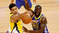 Malcolm Brogdon of Pacers (left) fights for ball possession against Draymond Green of Warriors