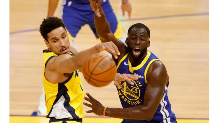 Malcolm Brogdon of Pacers (left) fights for ball possession against Draymond Green of Warriors