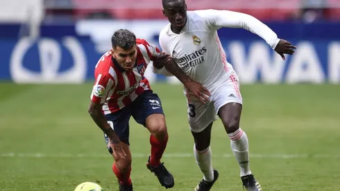 Angel Correa of Atletico Madrid (left) fights for ball control against Mendy of Real Madrid