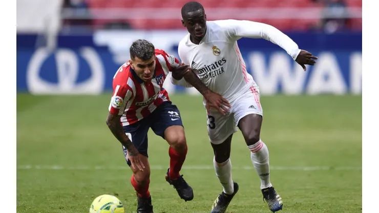 Angel Correa of Atletico Madrid (left) fights for ball control against Mendy of Real Madrid