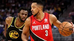 Andrew Wiggins of Warriors (left) tries to stop CJ McCollum of Portland Trail Blazers