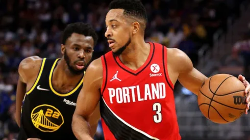 Andrew Wiggins of Warriors (left) tries to stop CJ McCollum of Portland Trail Blazers