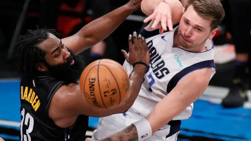 James Harden of Nets (left) fights the ball possession with Luka Doncic of Mavericks
