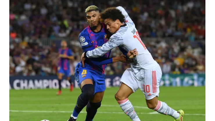 Ronald Araujo of FC Barcelona (left) fight for ball possession against Leroy Sane of Bayern Munich