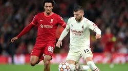 Trent Alexander-Arnold of Liverpool (left) tries to stop Ante Rebic of AC Milan