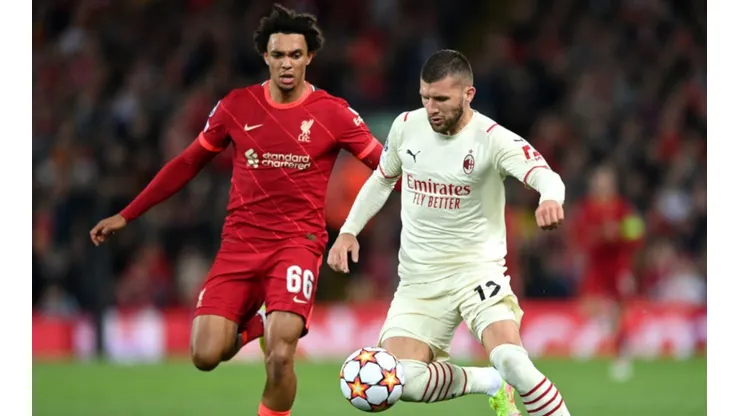 Trent Alexander-Arnold of Liverpool (left) tries to stop Ante Rebic of AC Milan