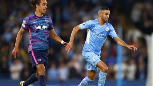 Yussuf Poulsen of RB Leipzig (left) tries to stop Riyad Mahrez of Manchester City