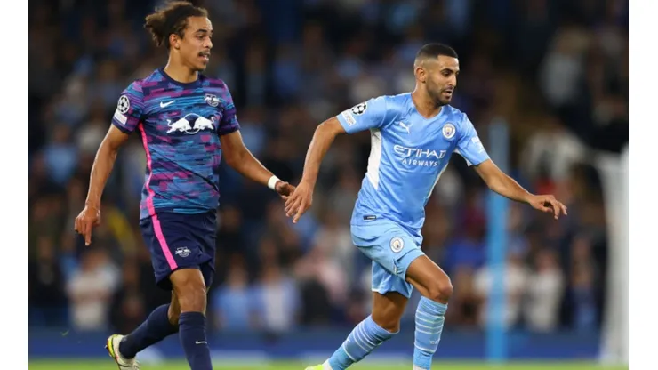 Yussuf Poulsen of RB Leipzig (left) tries to stop Riyad Mahrez of Manchester City