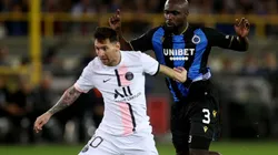 Lionel Messi of PSG (left) tries to hold ball possession against Eder Balanta of Club Brugge