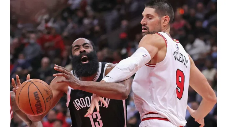 James Harden of Nets (lets) loses the ball against Nikola Vucevic of Bulls
