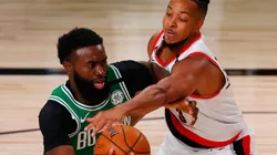 Jaylen Brown of Celtics (left) tries to avoid CJ McCollum of Blazers
