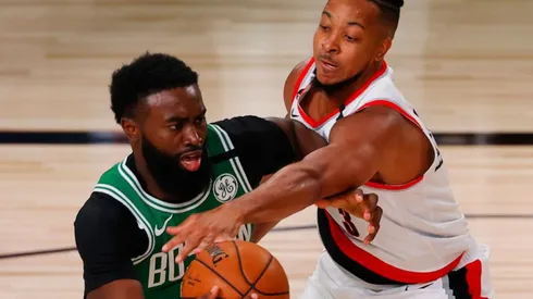Jaylen Brown of Celtics (left) tries to avoid CJ McCollum of Blazers