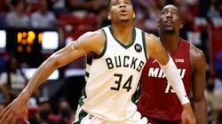 Giannis Antetokounmpo of Bucks (front) waits for a rebound with Bam Adebayo of Miami Heat