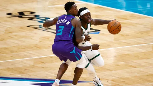 Terry Rozier of the Hornets (left) tries to block Jrue Holiday of the Bucks
