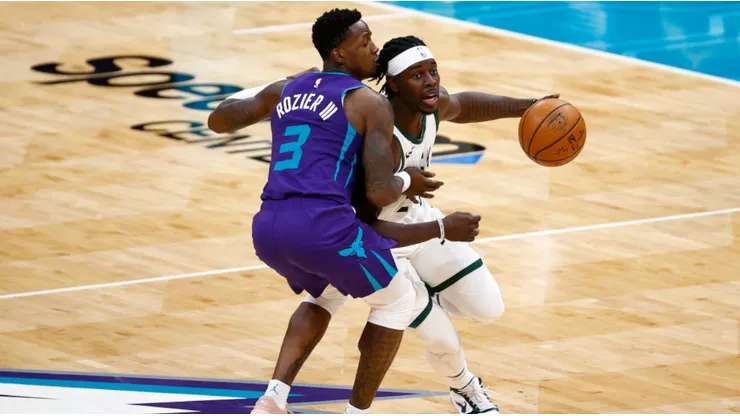 Terry Rozier of the Hornets (left) tries to block Jrue Holiday of the Bucks
