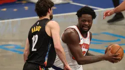 Joe Harris of Nets (left) tries to block Julius Randle of Knicks by Al Bello