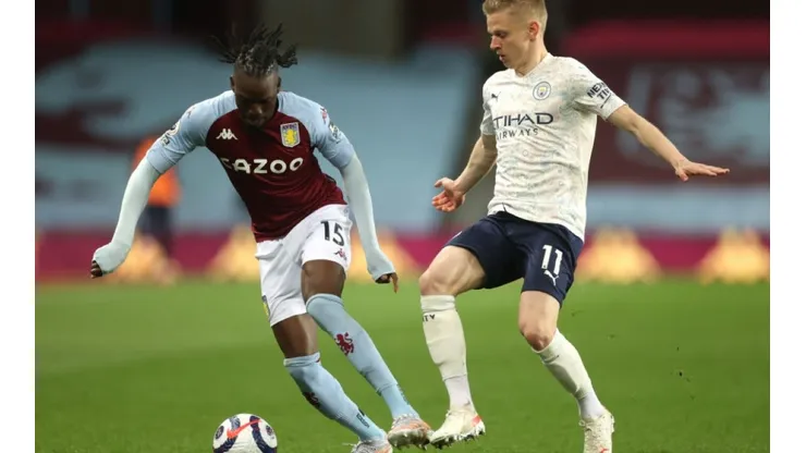 Bertrand Traore of Aston Villa (left) tries to avoid midfielder Oleksandr Zinchenko of Manchester City