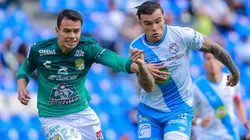 Christian Tabó #10 of Puebla (right) and Osvaldo Rodríguez #24 of León