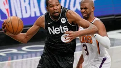 Kevin Durant of Brooklyn Nets (left) tries to pass drible Chris Paul of Phoenix Suns