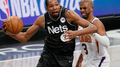 Kevin Durant of Brooklyn Nets (left) tries to pass drible Chris Paul of Phoenix Suns