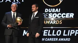 Marcello Lippi receives the Coach Career Award from Francesco Totti during the 2017 Globe Soccer Awards.