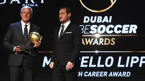 Marcello Lippi receives the Coach Career Award from Francesco Totti during the 2017 Globe Soccer Awards.