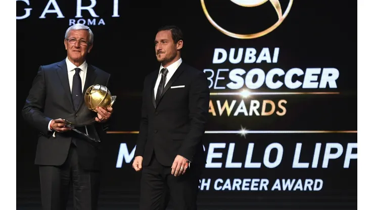 Marcello Lippi receives the Coach Career Award from Francesco Totti during the 2017 Globe Soccer Awards.