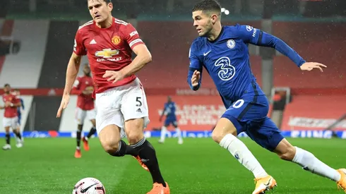 Harry Maguire of Manchester United battles for possession with Christian Pulisic of Chelsea.