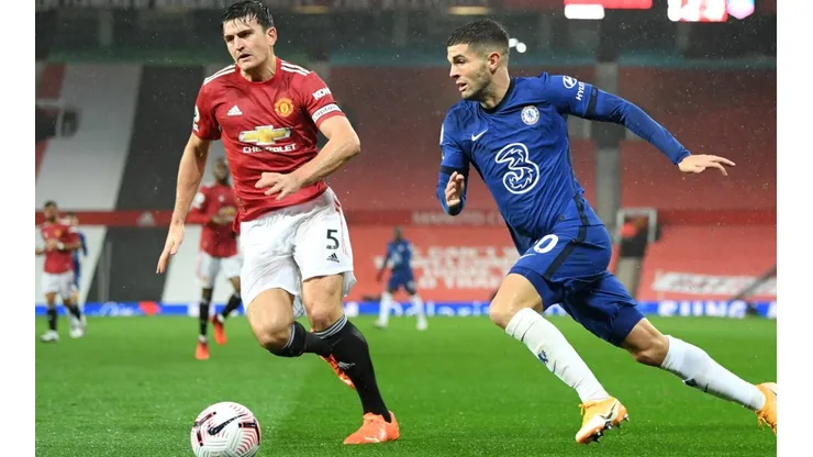 Harry Maguire of Manchester United battles for possession with Christian Pulisic of Chelsea.
