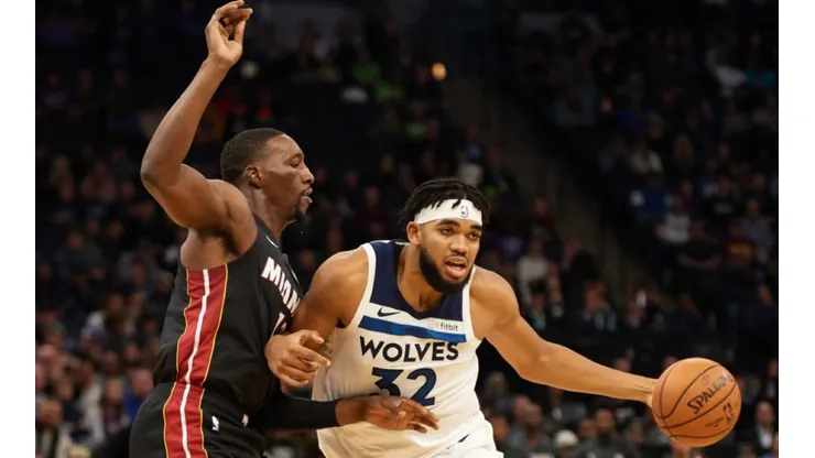 Bam Adebayo of Miami Heat (left) tries to block a shot from Karl-Anthony Towns of Minnesota Timberwolves