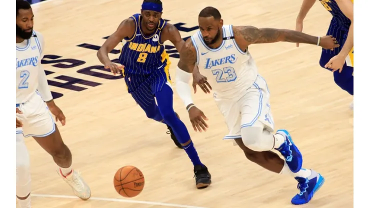 Justin Holiday of Indiana Pacers (left) tries to regain ball control against LeBron James of Lakers (Futbolsites)
