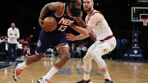 James Harden of Nets (left) tries to avoid Dean Wade of Cavaliers