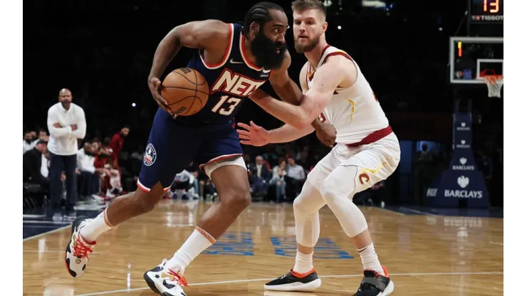 James Harden of Nets (left) tries to avoid Dean Wade of Cavaliers
