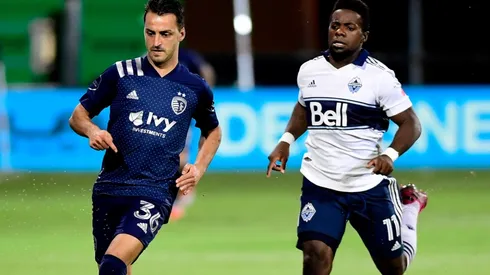 Luis Martins of Sporting Kansas City (left) against Cristian Dajome of Vancouver Whitecaps.