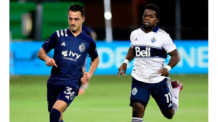 Luis Martins of Sporting Kansas City (left) against Cristian Dajome of Vancouver Whitecaps.