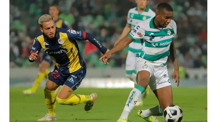 Juan Otero of Santos Laguna (right) protects the ball against Jose Hernandez of San Luis.