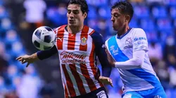 Antonio Briseño of Chivas (left) against Pablo Parra of Puebla.