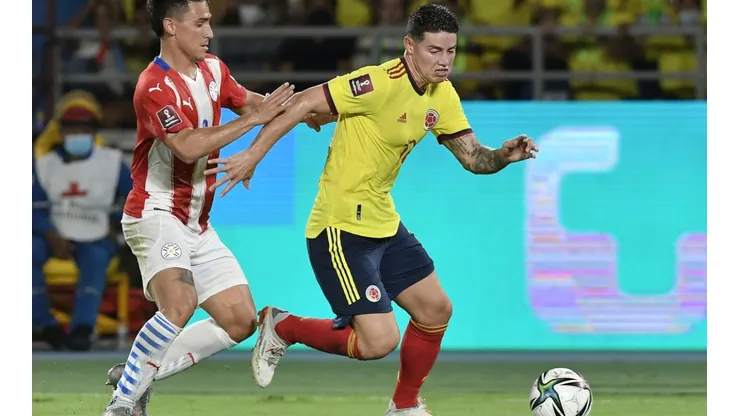 James Rodriguez of Colombia and Matias Rojas of Paraguay fight for the ball.