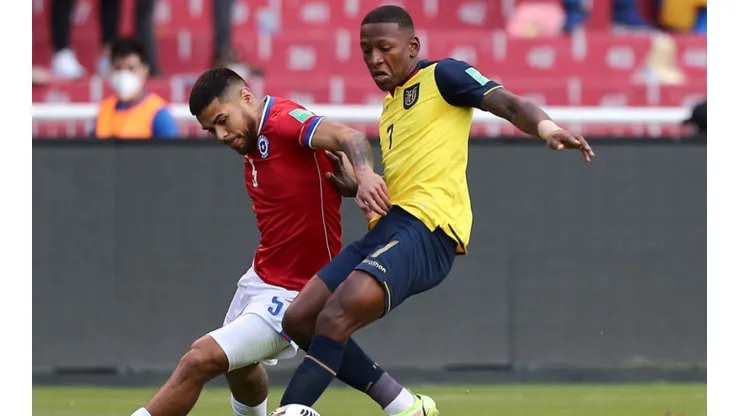Paulo Díaz of Chile (left) fights for ball possession against Pervis Estupiñan of Ecuador