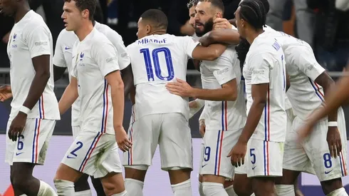 Karim Benzema of France (center) is congratulated by teammates