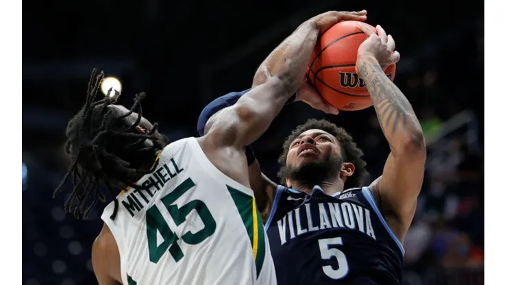 Davion Mitchell of the Baylor Bears (left) blocks a shot from Justin Moore of Villanova Wildcats