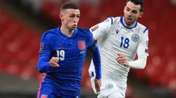 Phil Foden of England (left) and Luca Ceccaroli of San Marino (right)