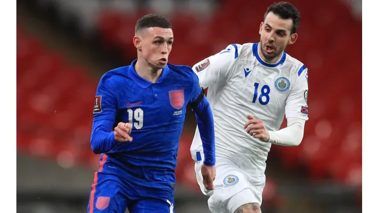 Phil Foden of England (left) and Luca Ceccaroli of San Marino (right)