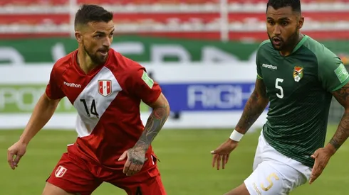 Gabriel Costa Heredia of Peru and Adrian Jusino of Bolivia fight for the ball.