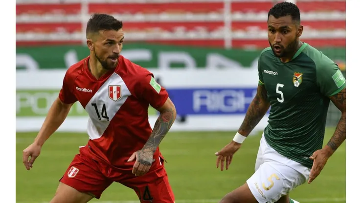 Gabriel Costa Heredia of Peru and Adrian Jusino of Bolivia fight for the ball.