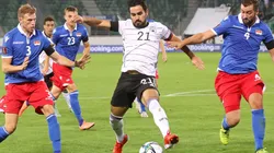 Ilkay Gundogan of Germany (center) is put under pressure by Max Goppel (left) and Daniel Kaufmann (right) of Liechtenstein
